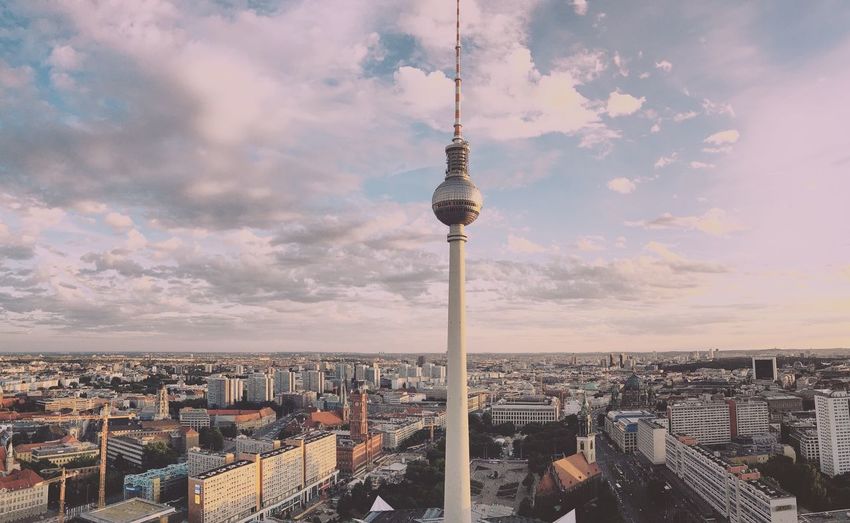 Urban skyline against cloudy sky