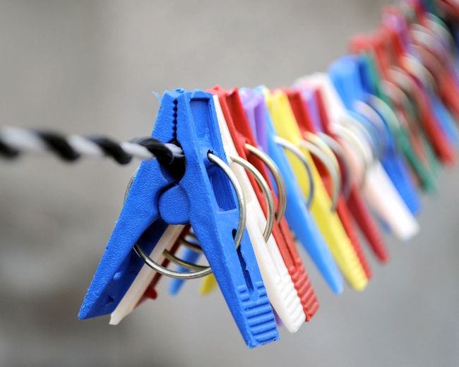 Close-up of multi colored clothes hanging on rope