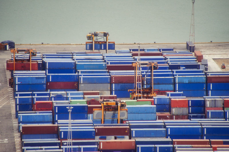 Stack of pier with cargo container against blue sky