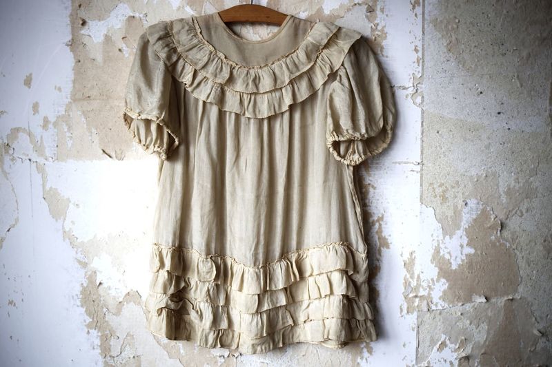Old dress hanging on weathered wall