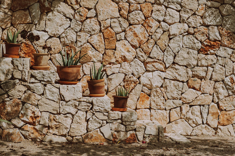 View of stone wall and rocks against building