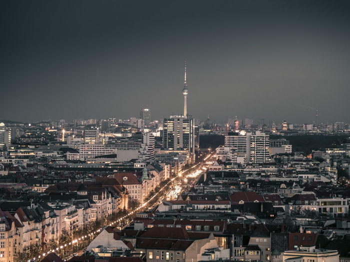 Illuminated cityscape against sky