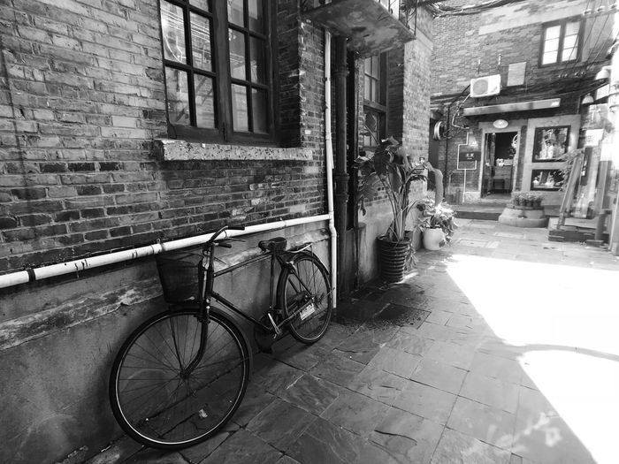 Bicycle parked on street by buildings