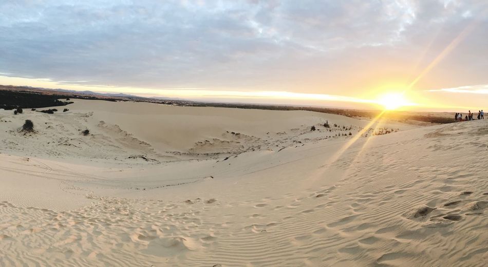 Scenic view of beach against sky during sunset