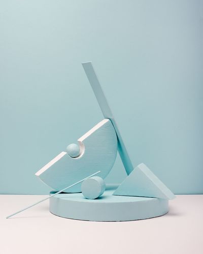 CLOSE-UP OF WIND TURBINE ON TABLE AGAINST WALL