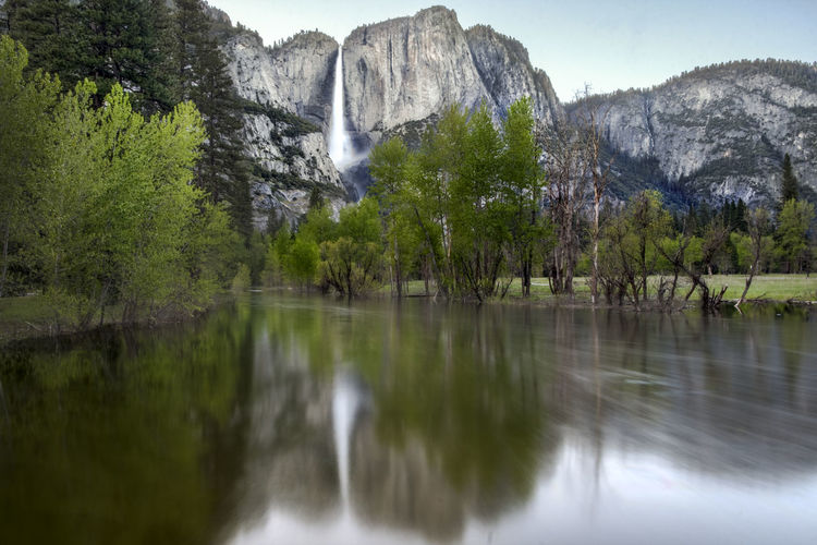Scenic view of waterfall by lake