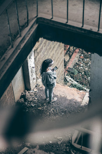 High angle view of child standing on window