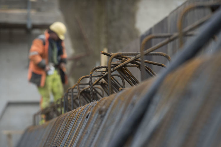 Construction worker and reinforced concrete, building at the construction site