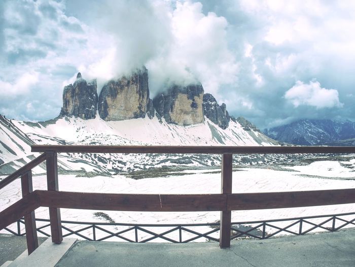Breathtaking view from mountain hut terrace to symbol of italian dolomites - tre cime. rocky ridge