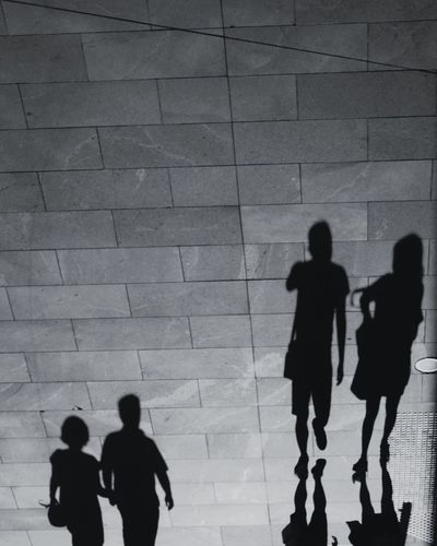 Silhouette people walking in corridor