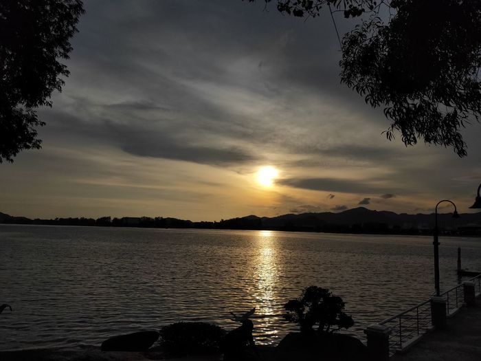 Scenic view of lake against sky during sunset