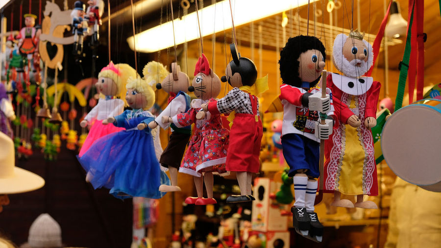 Traditional wooden puppet toys hang at a market stalls in prague, cz. marionette puppet toys.