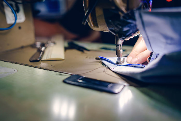 High angle view of man working on sewing machine