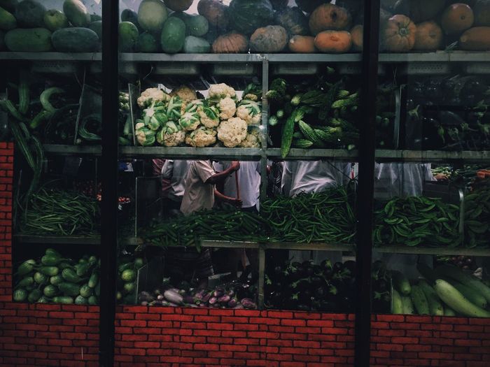 Vegetables in store seen through window glass