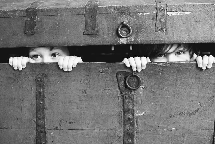 Close-up of children hiding in trunk