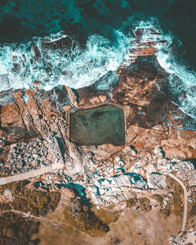High angle view of rock formations in sea