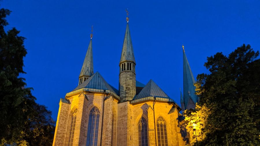 Low angle view of buildings against blue sky