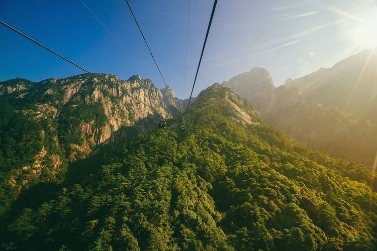 Close-up of cable cars against mountains
