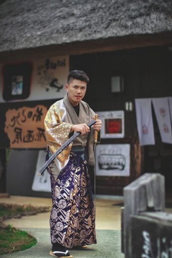 Full length of man wearing traditional clothing while standing outdoors