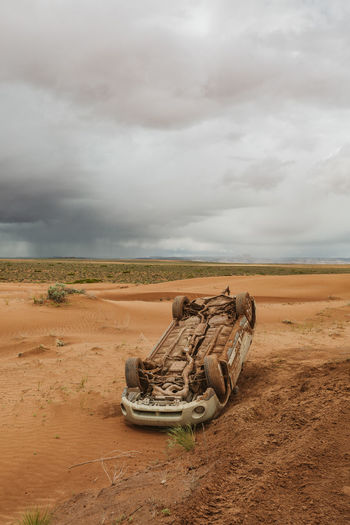 Subaru flipped on a slippery dirt mud road in the desert of utah