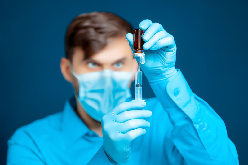 Doctor preparing syringe in hospital