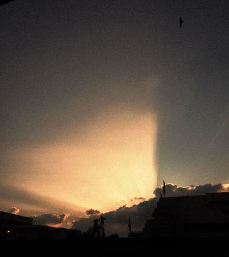 Low angle view of silhouette building against sky during sunset