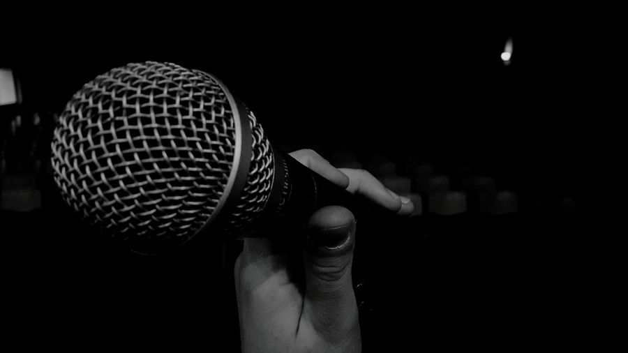 Side view of hand holding microphone