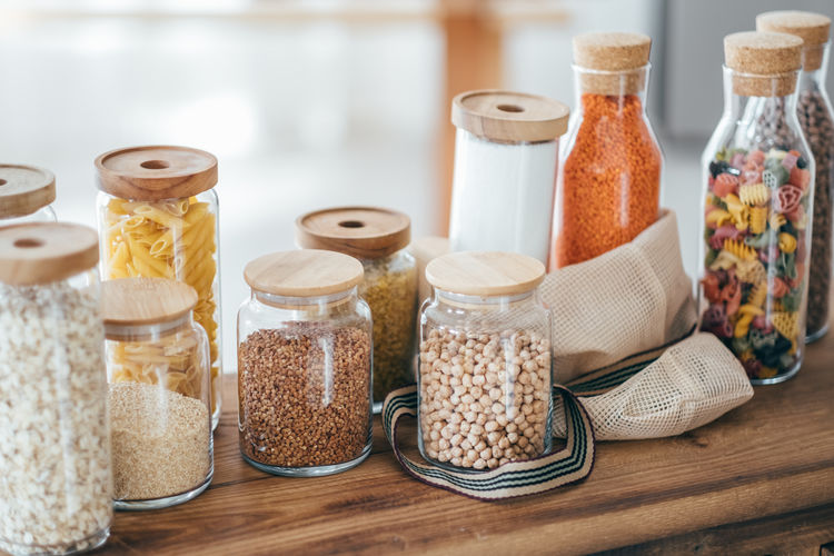 Zero waste concept. textile eco-bags glass jars on wooden table in the kitchen.