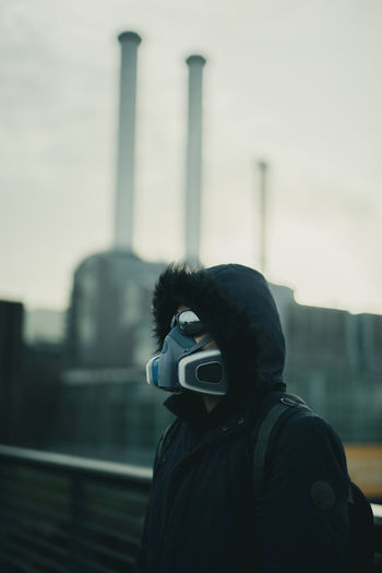 Portrait of man with mask photographing against camera