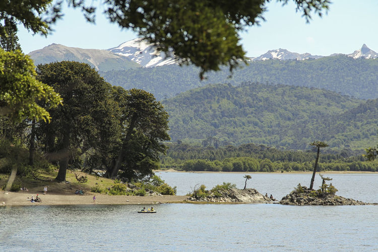 Scenic view of river and mountains against sky