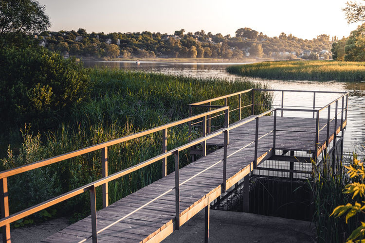 Sun illuminates a small pier by the river.  concept of outdoor recreation and calm life. relaxation