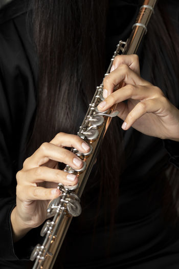 Golden flute played by a young woman