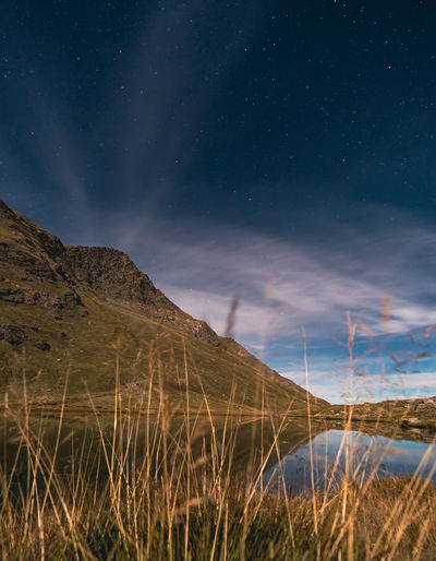 Scenic view of mountains against sky at night