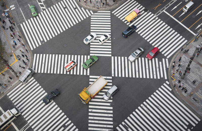 High angle view of vehicles on zebra crossing in city