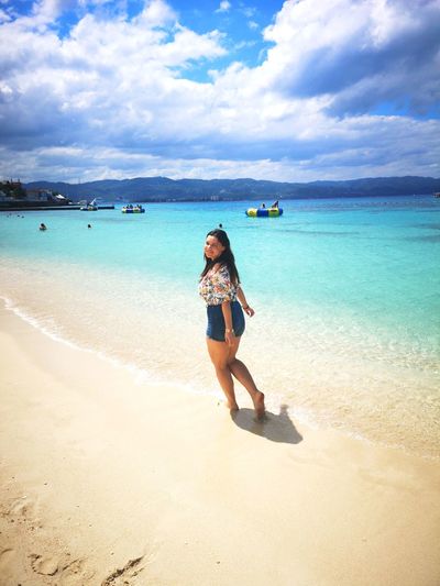 Full length of woman on beach against sky
