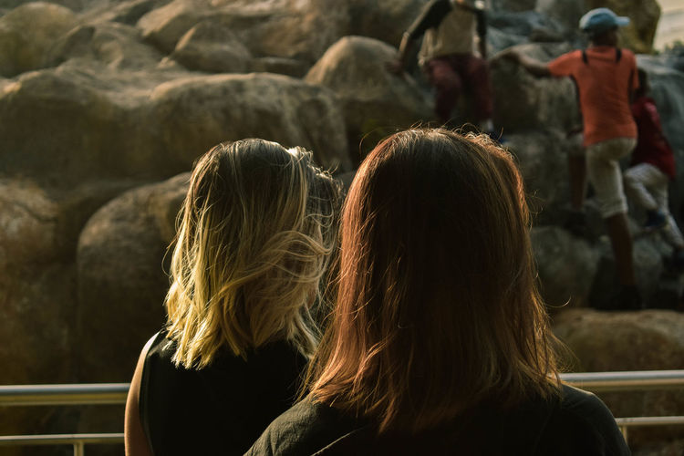 Rear view of women outdoors