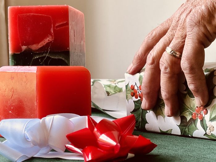 Cropped hand of woman holding christmas presents