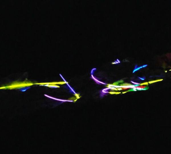 Close-up of illuminated lights over black background