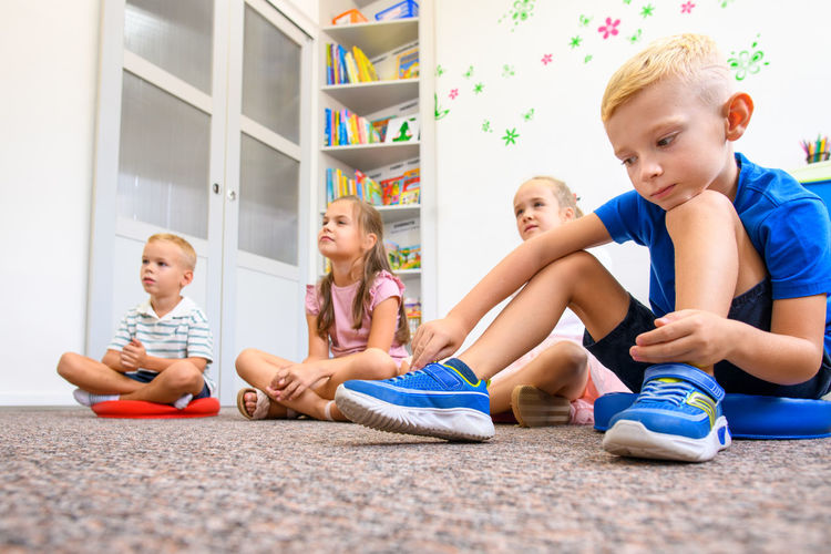 Elementary age children in group therapy. pupils in class sitting on the floor.