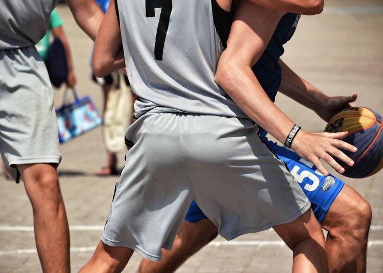 Midsection of sports player playing on court