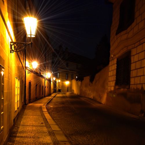 Empty illuminated street lights at night
