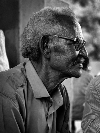 Close-up portrait of old man looking away
