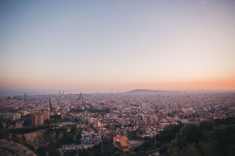 High angle view of buildings against clear sky during sunset