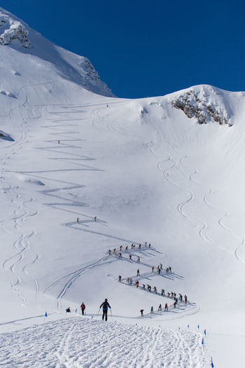 Group of people skiing on snowcapped mountain