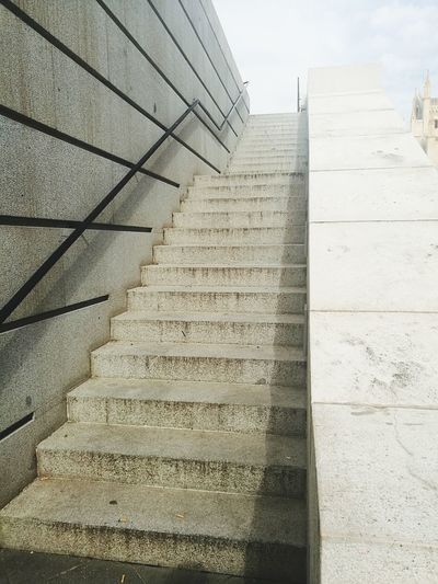 Low angle view of steps in city against sky
