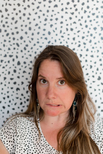 Portrait of woman against wall