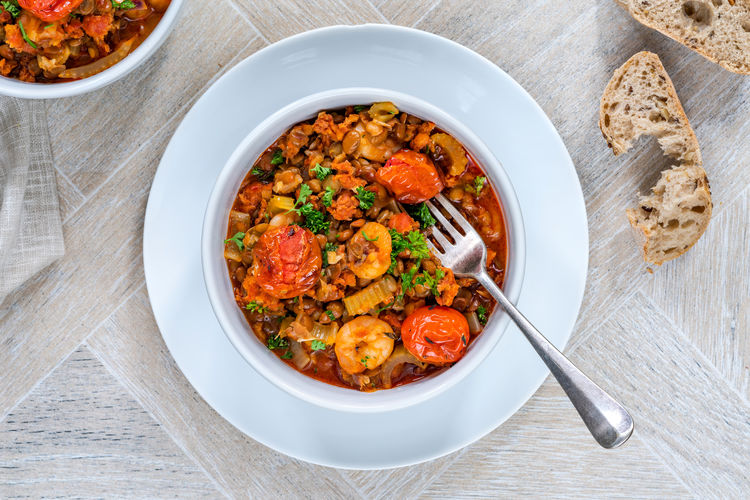 Chorizo, lentil and prawn stew with roasted tomatoes - overhead view