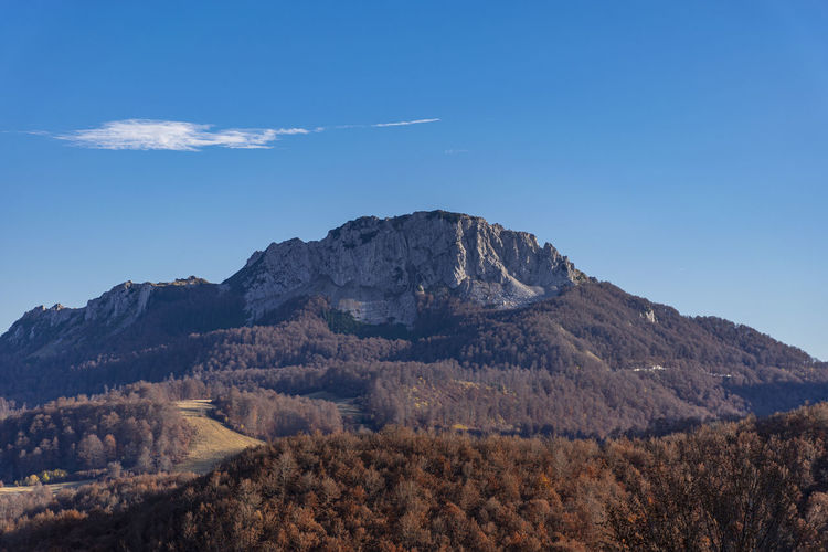Scenic view of mountains against blue sky