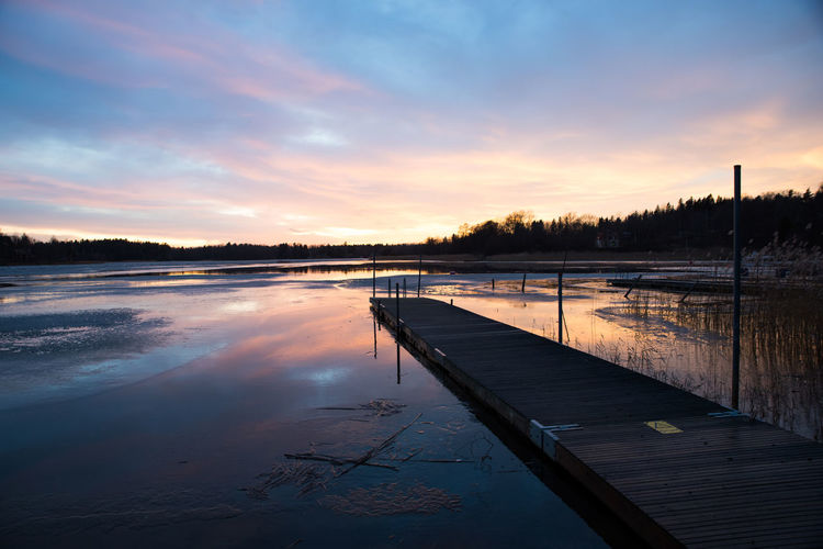 View of lake against cloudy sky during sunset