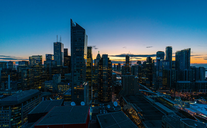 Aerial view of buildings in city during sunset